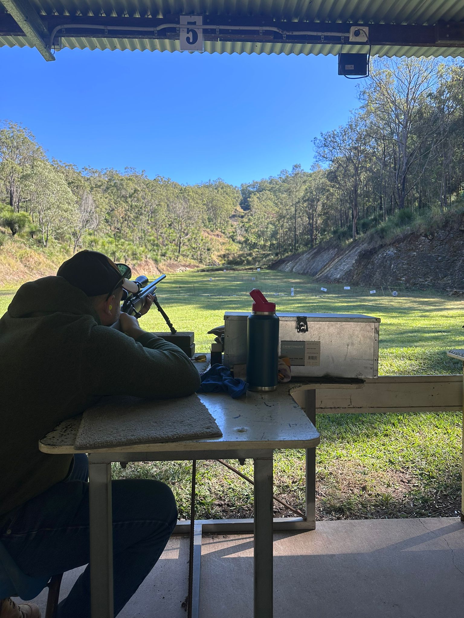 Shooter at the bench taking aim down the range at Wattle Grove Park